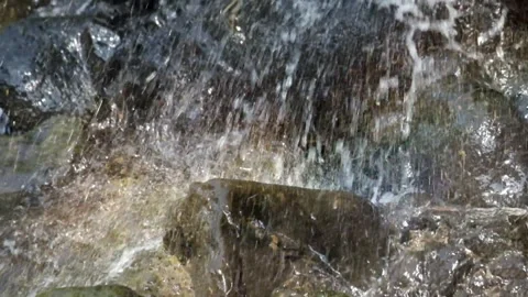 Close up of splashing waterfall falling on rocks Stock Footage 319886534