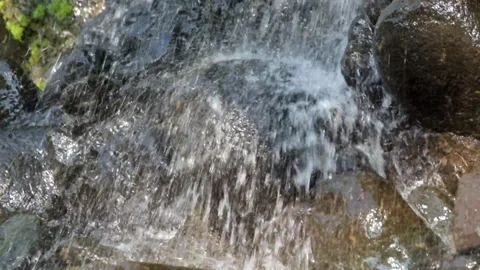 Close up of splashing waterfall falling on rocks Video stock 319886725