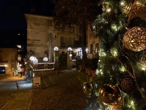 Close up of a splendid Christmas tree that frames an enchanting town on a lak Stock Photos