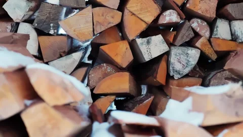 Close-up of split firewood with snow between logs, rustic homestead stockpile 스톡 동영상 327829923