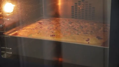Close-up of sponge dough with strawberries baked in a oven in a pastry kitchen. Stock Footage 270064352