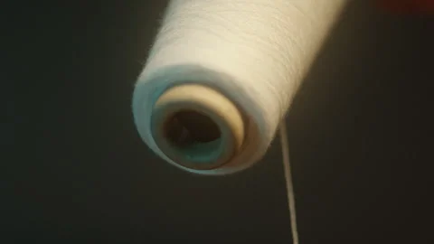 Close up of spool of white thread Stock Footage 311112482