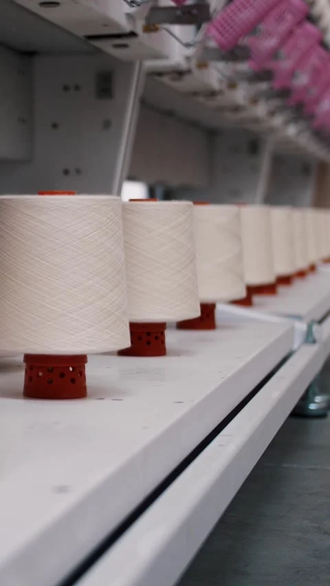Close-up spools of yarn thread. Textile factory. Spinning production. Threads Stock Footage 317314438