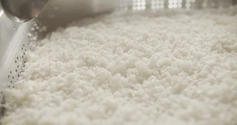 Close-up of spoon is carried out over the grained homemade cottage cheese. 4K Stock Footage 123045607