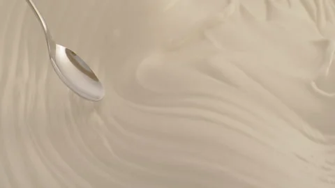 Close-Up of Spoon Dipping Smoothly into Thick Cream with Luscious Texture Stock Footage 220609411