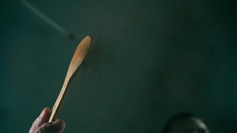 Close-up of a spoon dropping tea into the camera Stock Footage 328442374