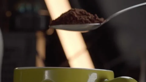 Close up of spoon pouring coffee powder into green ceramic cup during drink Stock Footage 343710853
