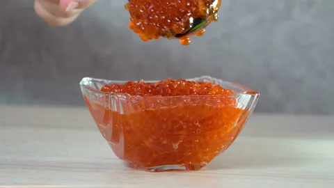 Close-up. Spoon put caviar in a glass vase 4K Stock Footage 127600833