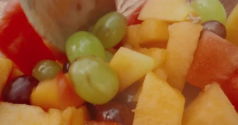 Close-up of a spoon scooping up a serving of fresh fruit salad Stock Footage 138135732