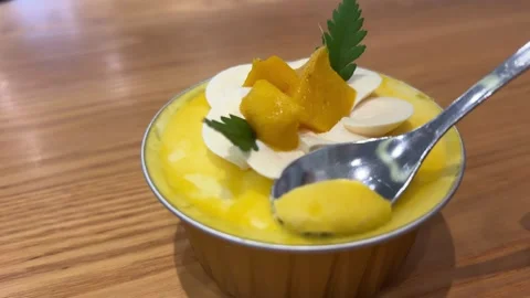 Close-up of the spoon slowly scooping frozen mango ice-cream gelato on the Stock Footage 307671002