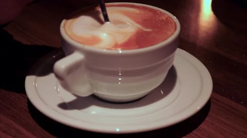 Close-up of a spoon stirring cappuccino in a cup. Side view. reverse time Stock Footage 228827133