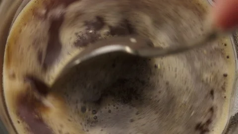 Close-up of a spoon stirring a cup of coffee Stock Footage 237563673