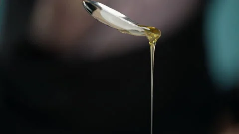 Close-up of a spoon from which honey is poured. Stock Footage 159996991