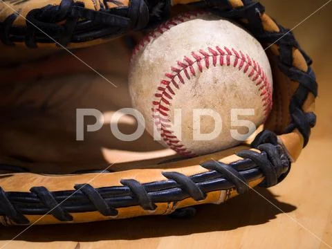 Close up sports background image of an old used weathered leather baseball wi Stock Photos
