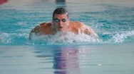 Close-Up - The Sportsman Swimming Butterfly In The Blue Water Stock Footage