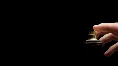 Close up of a spray bottle drops on black background. Male perfume bottle on a Stock-Footage 84232597