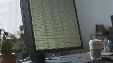 Close-up of Spreadsheet on Screen of Office Computer Placed on Grey Work Desk Stock Footage 312043980
