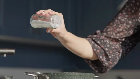 Close Up of Sprinkling Salt During Cooking Stock Footage 336466804