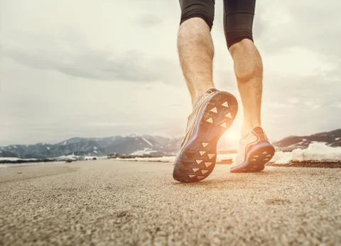 Close up sprinter legs on asphalt Stock Photos