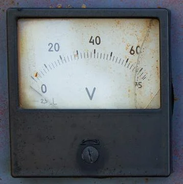 Close-up of a square analog voltmeter with a scale from 0 to 60 "V" (volts). Stock Photos