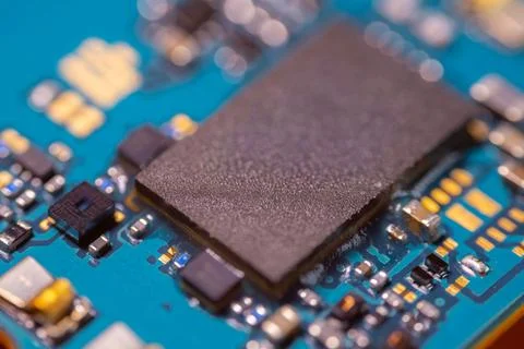 Close up of square electronic processor with textured surface mounted on a .. Stock Photos