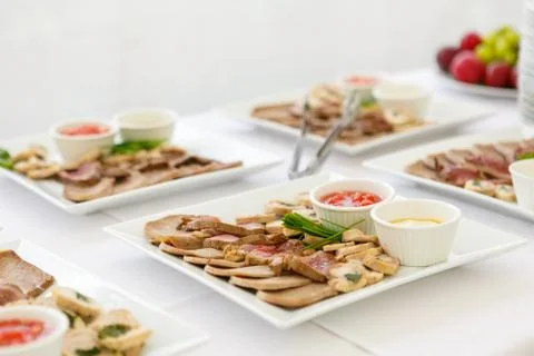 A close up of square plates with meat assorted Stock Photos