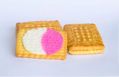 Close up of square shape cream biscuits filled with white and pink cream  iso Stock Photos