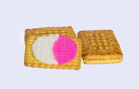 Close up of square shape cream biscuits filled with white and pink cream  iso Stock Photos