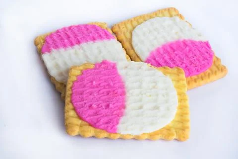 Close up of square shape cream biscuits filled with white and pink cream  iso Stock Photos