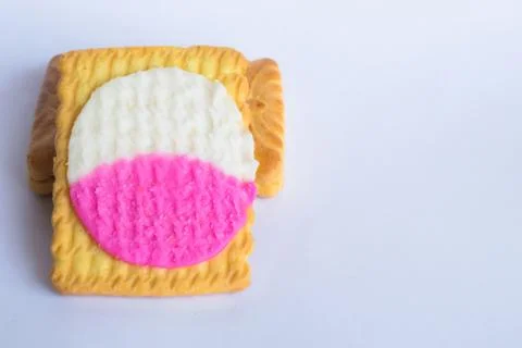 Close up of square shape cream biscuits filled with white and pink cream  iso Stock Photos