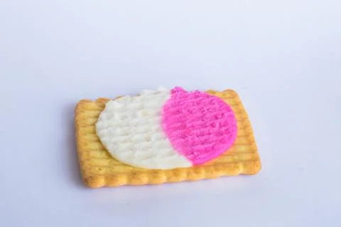 Close up of square shape cream biscuits filled with white and pink cream  iso Stock Photos