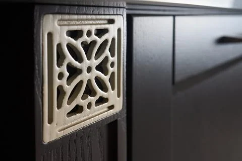 Close up square shape lattice element of brightly lit wooden painted cabinet Foto stock