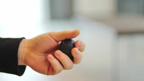 Close-Up of Squash Ball Held in Hand Before Serve on Bright Indoor Background Stock Footage 307168424