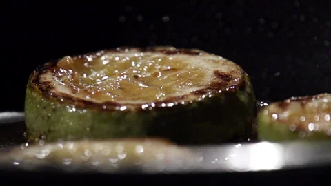 Close up of squash that is being pan-fried with splashing oil Stock Footage 113496980