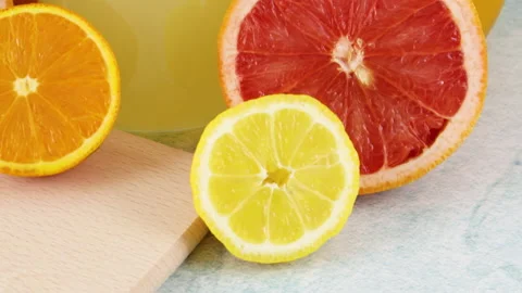 Close up of squeezed orange juice and lemonade with citrus fruits Stock Footage 131683668