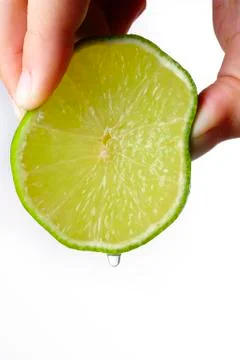 Close up squeezing a lime Stock Photos