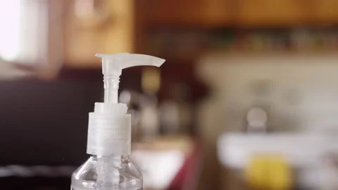 Close up squeezing liquid hand sanitizer on hands with shallow focus Video stock 134281686