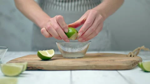 Close-up of squeezing wage lemon in a small glass bowl. Stock Footage 132788994