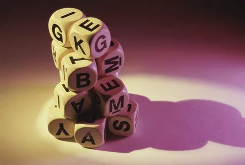 Close-up of a stack of alphabetic dice Stock Photos