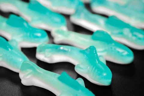 A close-up of a stack of blue and white gummy shark candies. Stock Photos