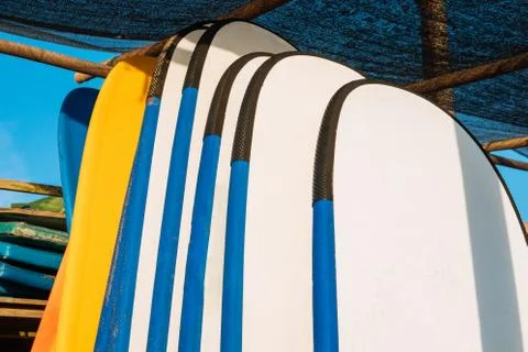 Close up stack of blue color soft surfboards in a stack by ocean.Bali.Indones Stockfoto's