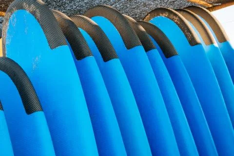 Close up stack of blue color soft surfboards in a stack by ocean.Bali.Indones Fotos de archivo