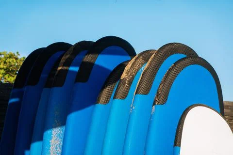 Close up stack of blue color soft surfboards in a stack by ocean.Bali.Indones Stock Photos