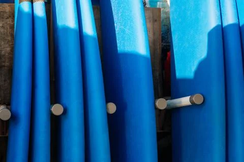 Close up stack of blue color soft surfboards in a stack by ocean.Bali.Indones Stockfoto's