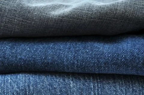 Close up stack of blue jeans abstract Stock Photos
