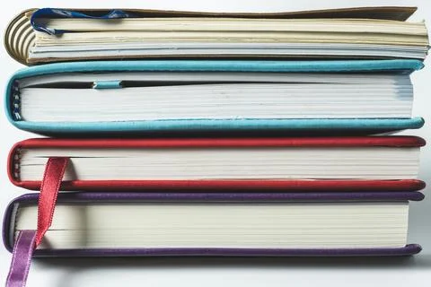 Close up stack of books on white background Stock Photos