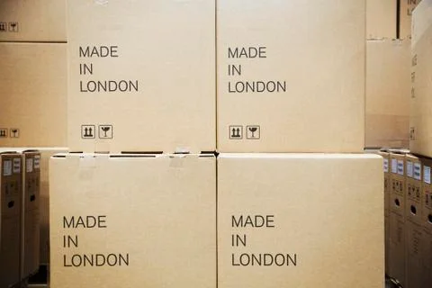 Close up of stack of cardboard boxes labelled 'Made in London;'. Stock Photos