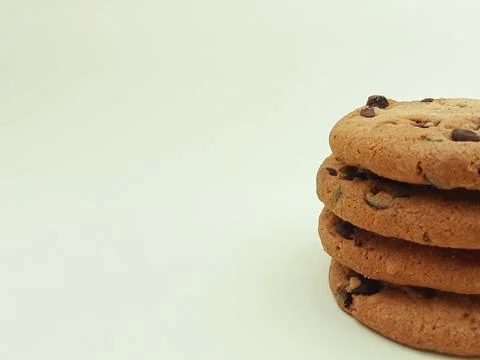 Close up stack of chocolate chip cookies on white background Stock Photos