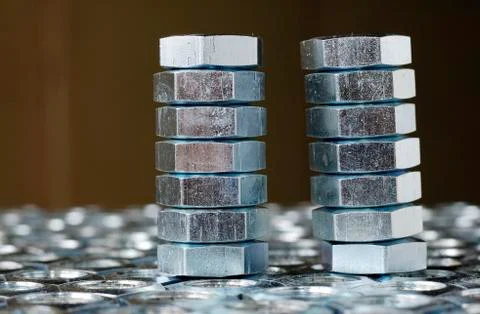 Close-up of a stack of chrome metal nuts Stock Photos