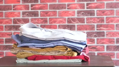 Close up of stack of clothes on table . Stock Footage 144819882